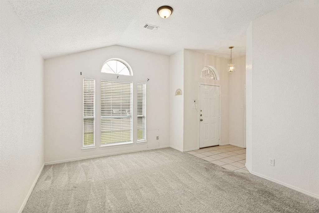 7120 Nohl Ranch Road Fort Worth, TX 76133 - Photo 3 of 14 Vaulted ceiling great room with a large arched window and light gray carpet