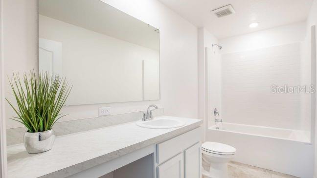 15061 Hummingbird Road Weeki Wachee, FL 34614 - Photo 14 of 21 a bathroom with a sink a toilet and tub