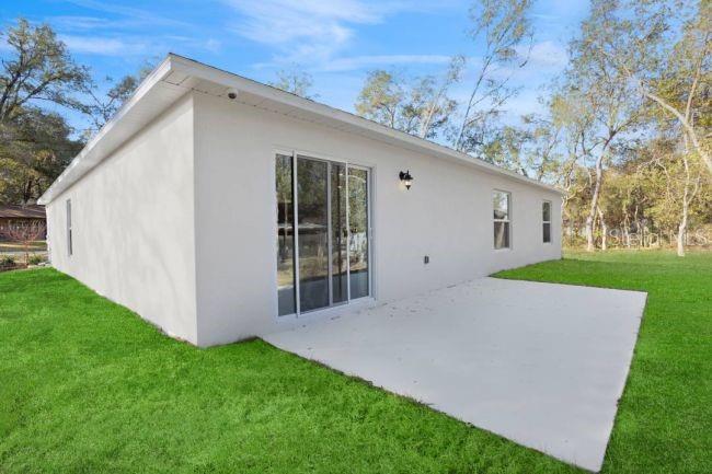 15061 Hummingbird Road Weeki Wachee, FL 34614 - Photo 16 of 21 a view of backyard with large trees and plants