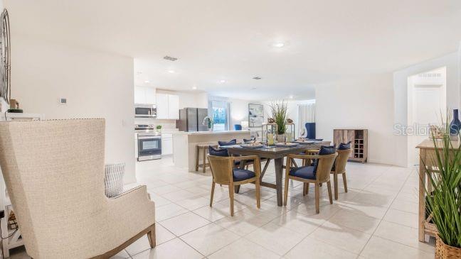 15061 Hummingbird Road Weeki Wachee, FL 34614 - Photo 7 of 21 a dining room with furniture and kitchen view