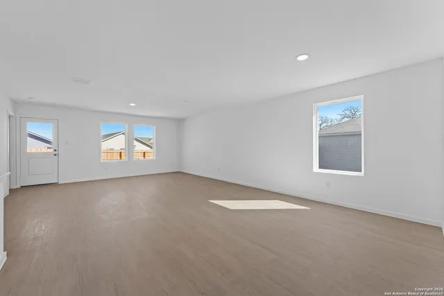 a view of kitchen with stainless steel appliances granite countertop refrigerator stove top oven and cabinets