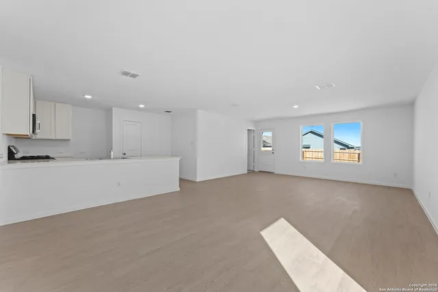 a kitchen with granite countertop a stove top oven and sink