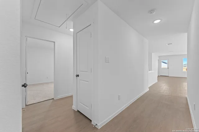 a bathroom with a toilet sink a mirror and shower