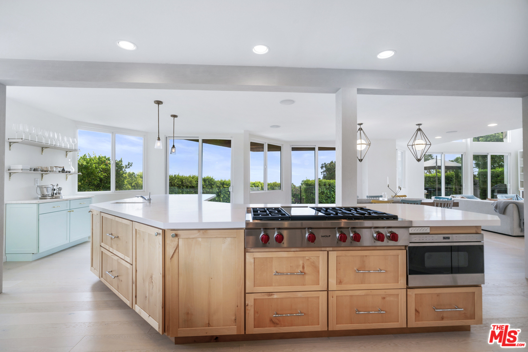 6272 Cavalleri Road Malibu, CA 90265 - Photo 12 of 47 a kitchen with stainless steel appliances a stove and more cabinets