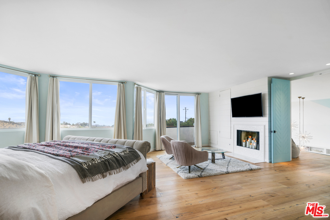 6272 Cavalleri Road Malibu, CA 90265 - Photo 17 of 47 a bedroom with a bed and a flat screen tv