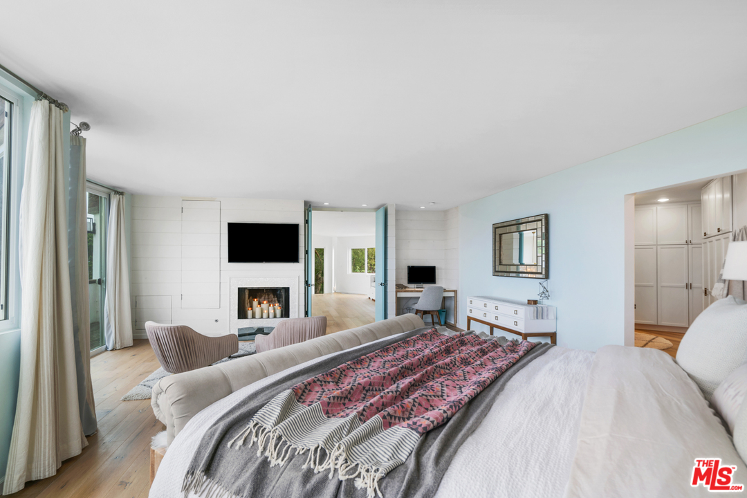 6272 Cavalleri Road Malibu, CA 90265 - Photo 18 of 47 a bedroom with a bed and a flat screen tv