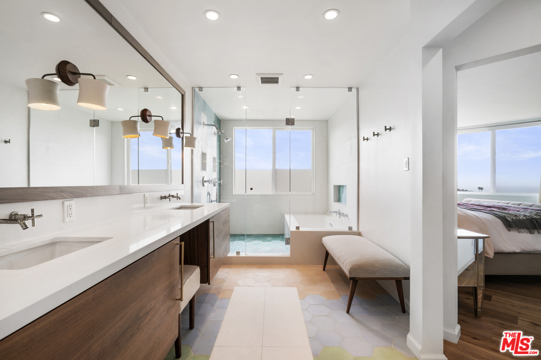 6272 Cavalleri Road Malibu, CA 90265 - Photo 21 of 47 a spacious bathroom with a granite countertop sink mirror and a bathtub