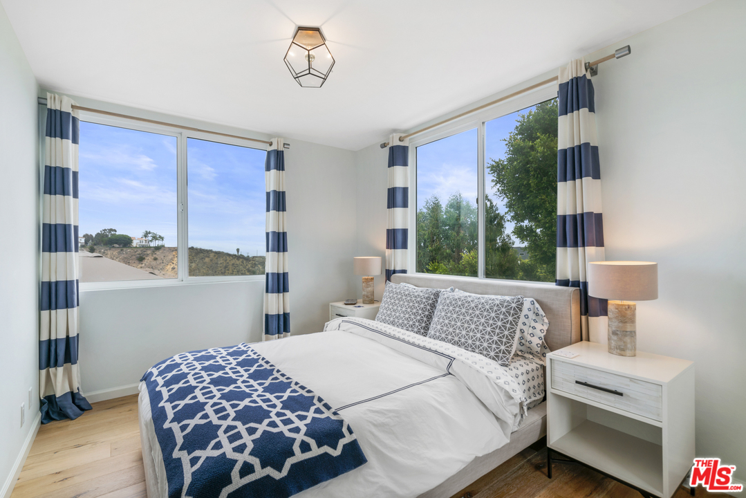 6272 Cavalleri Road Malibu, CA 90265 - Photo 32 of 47 a bedroom with a bed and a table in it