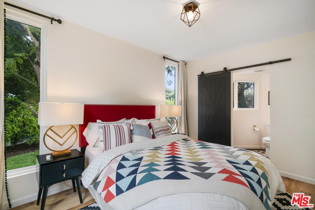6272 Cavalleri Road Malibu, CA 90265 - Photo 35 of 47 a bedroom with a bed and a chandelier