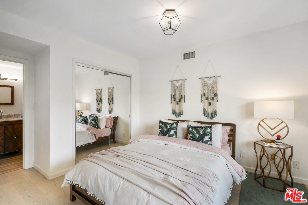 6272 Cavalleri Road Malibu, CA 90265 - Photo 37 of 47 a bedroom with a bed and a chandelier