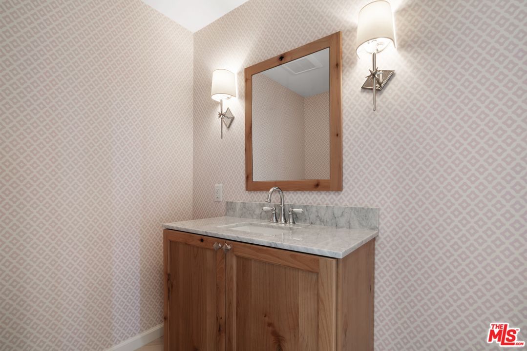 6272 Cavalleri Road Malibu, CA 90265 - Photo 39 of 47 a bathroom with a sink vanity and a mirror