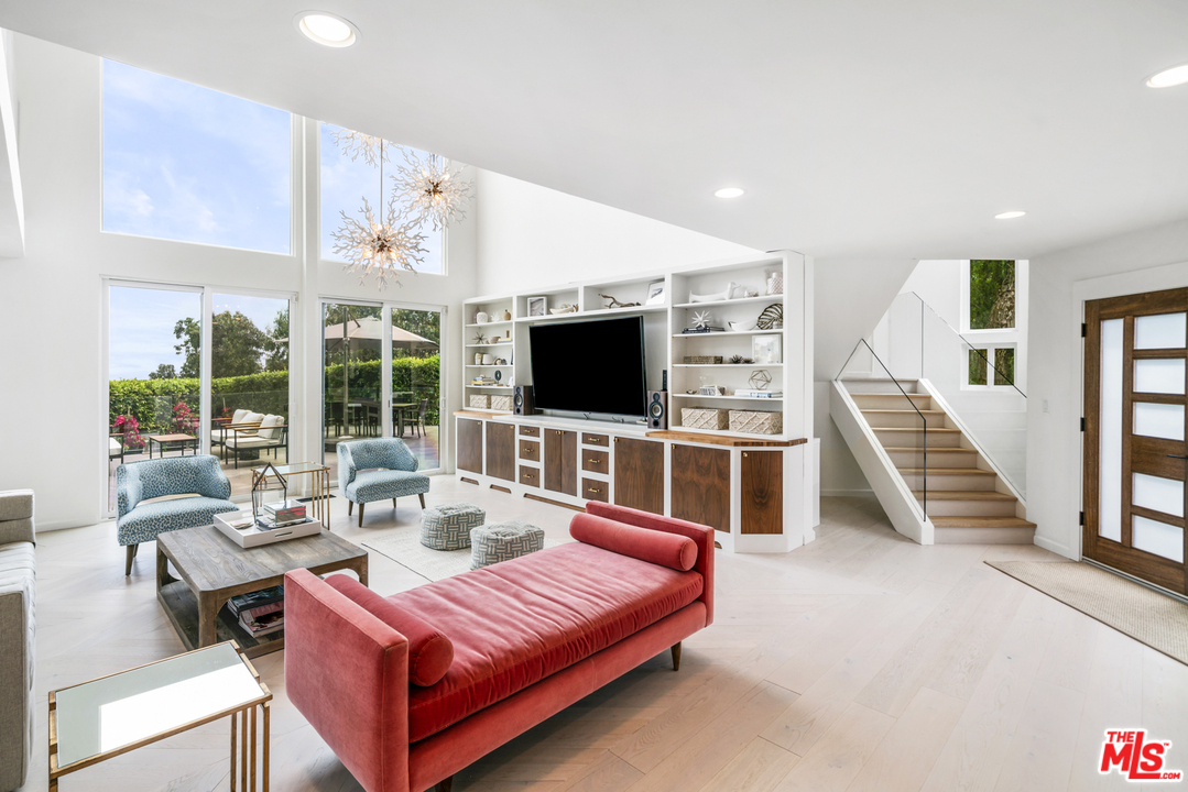 6272 Cavalleri Road Malibu, CA 90265 - Photo 7 of 47 a living room with furniture a flat screen tv and a floor to ceiling window