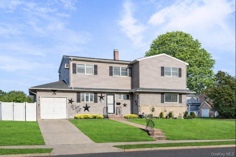2 Kroll Street Plainview, NY 11803 - Photo 4 of 29 a front view of a house with a yard