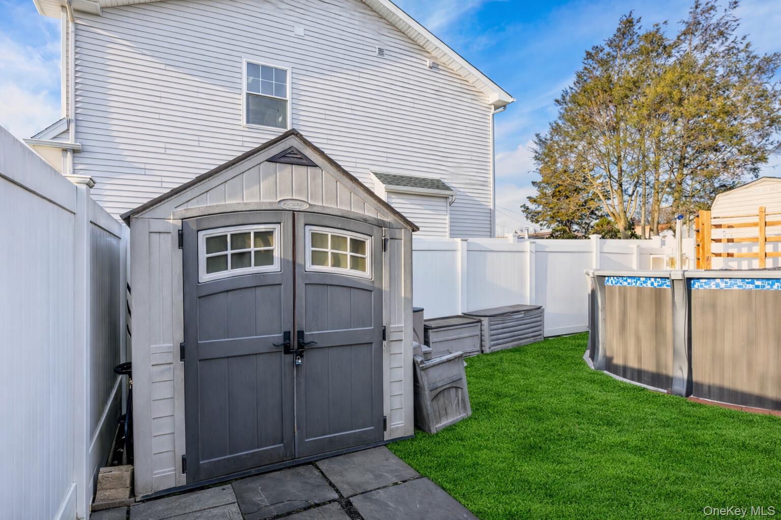 2 Kroll Street Plainview, NY 11803 - Photo 10 of 29 a view of backyard with wooden fence and a large tree
