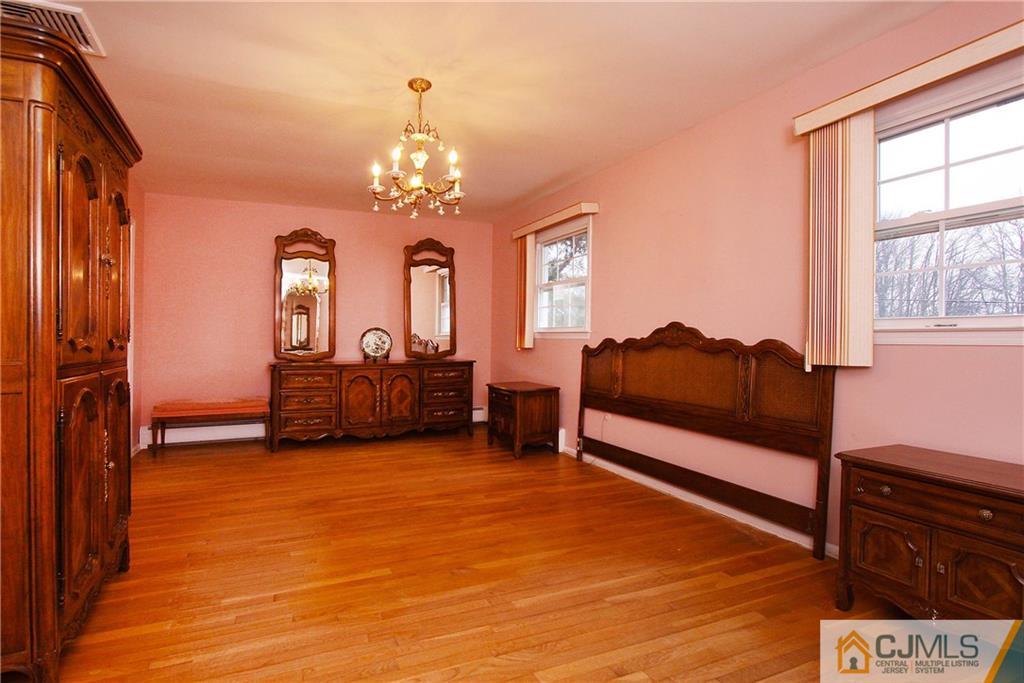 9 Cardinal Avenue Edison, NJ 08820 - Photo 12 of 20 a living room with furniture and a chandelier
