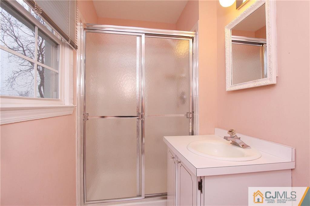 9 Cardinal Avenue Edison, NJ 08820 - Photo 13 of 20 a bathroom with a sink toilet and vanity