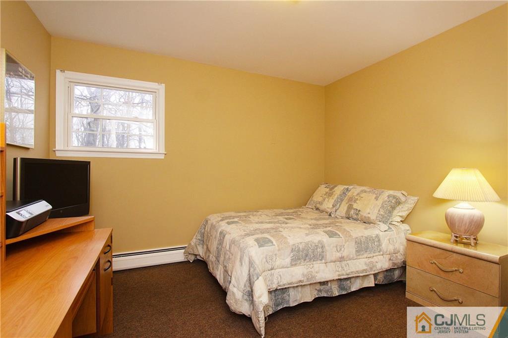 9 Cardinal Avenue Edison, NJ 08820 - Photo 14 of 20 a bedroom with a bed and a window