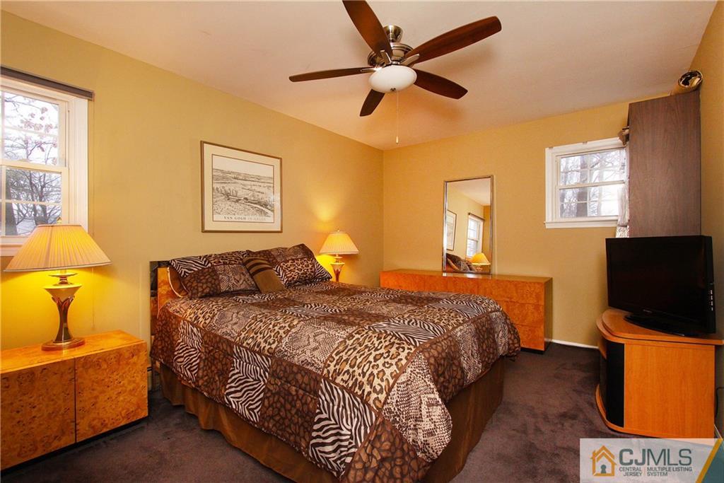 9 Cardinal Avenue Edison, NJ 08820 - Photo 15 of 20 a bedroom with a bed and a flat screen tv