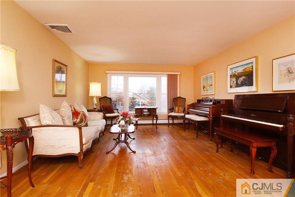 9 Cardinal Avenue Edison, NJ 08820 - Photo 4 of 20 a living room with furniture and a wooden floor