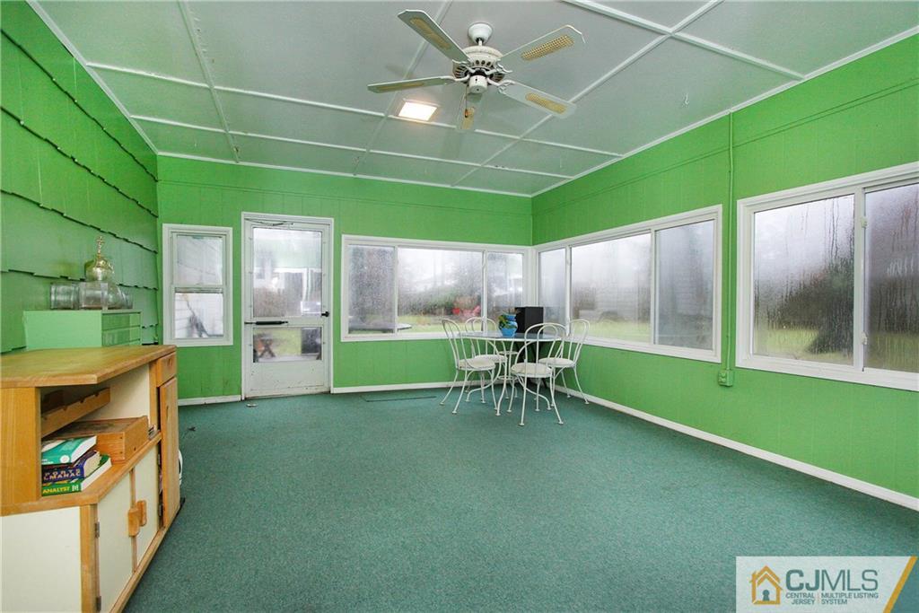 9 Cardinal Avenue Edison, NJ 08820 - Photo 10 of 20 a view of a porch with chairs and a yard