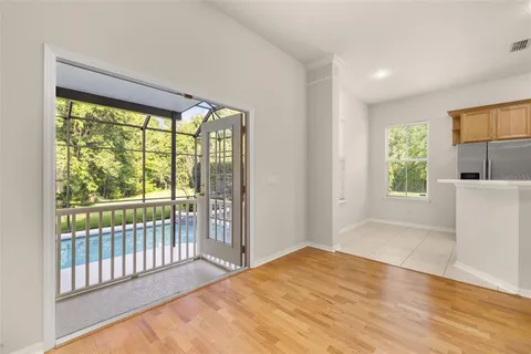 a view of a room with wooden floor and a window