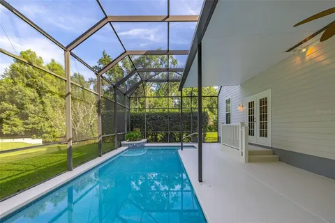 a view of swimming pool with a patio and a yard