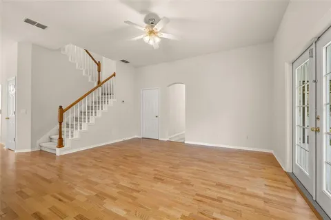 a view of staircase with wooden floor and white walls