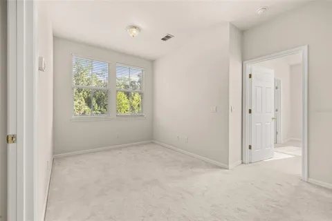 a bed room with bed and a chandelier