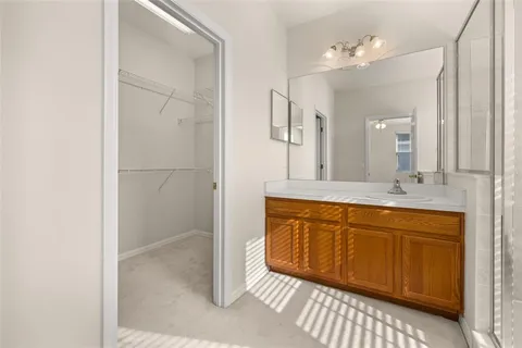 a view of an empty room with closet and a window