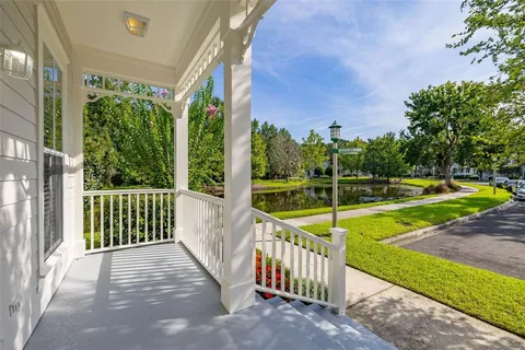 a view of a house with a small yard and a porch