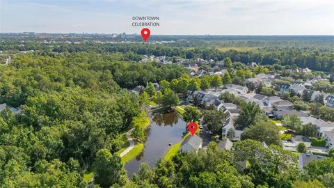 a aerial view of multi story residential apartment building with yard and parking space