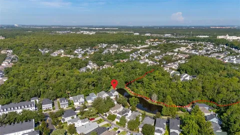 a front view of a house with a yard and potted plants