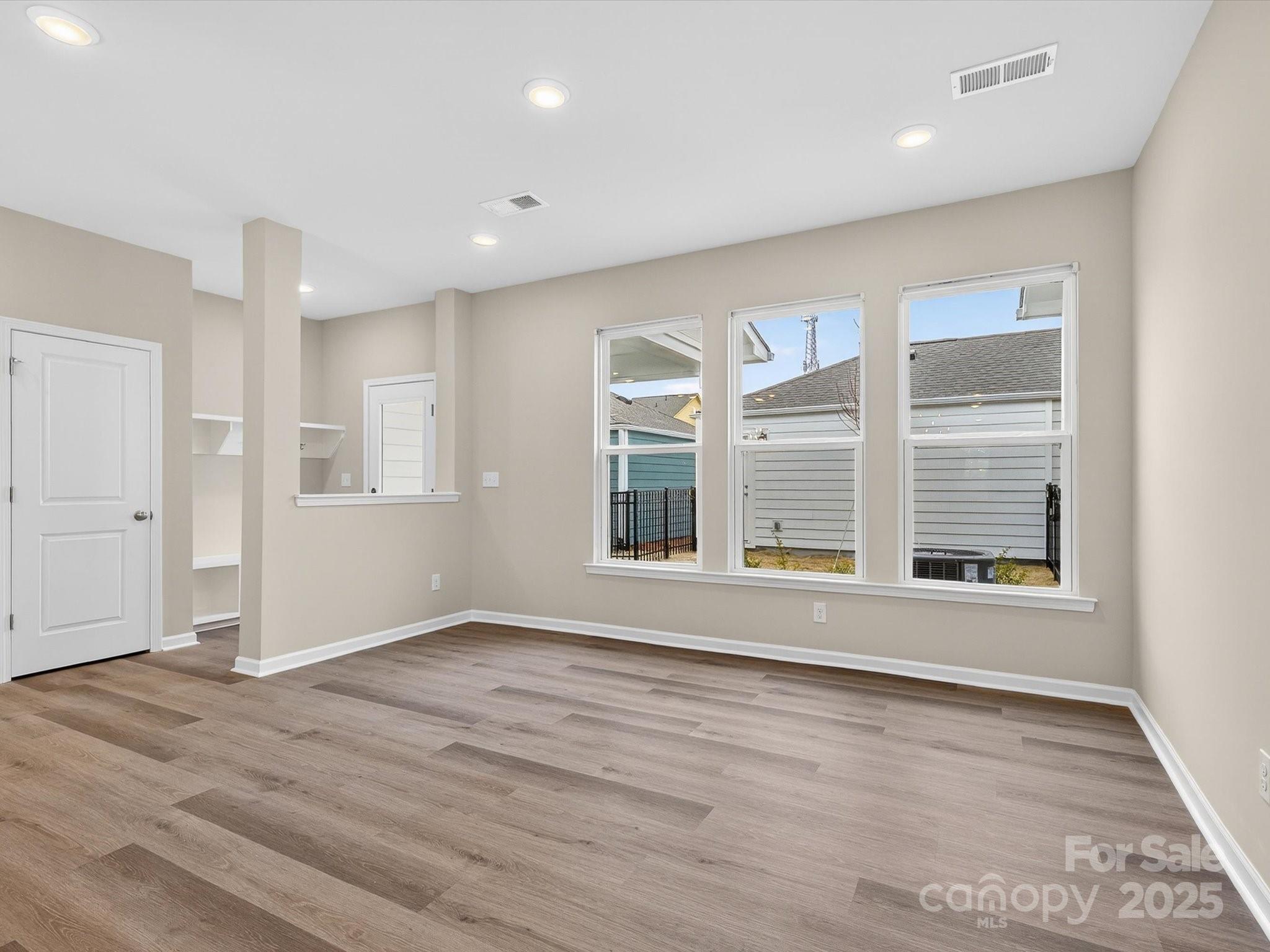 11439 Prosperity Church Road Huntersville, NC 28078 - Photo 12 of 34 a view of an empty room with wooden floor and a window