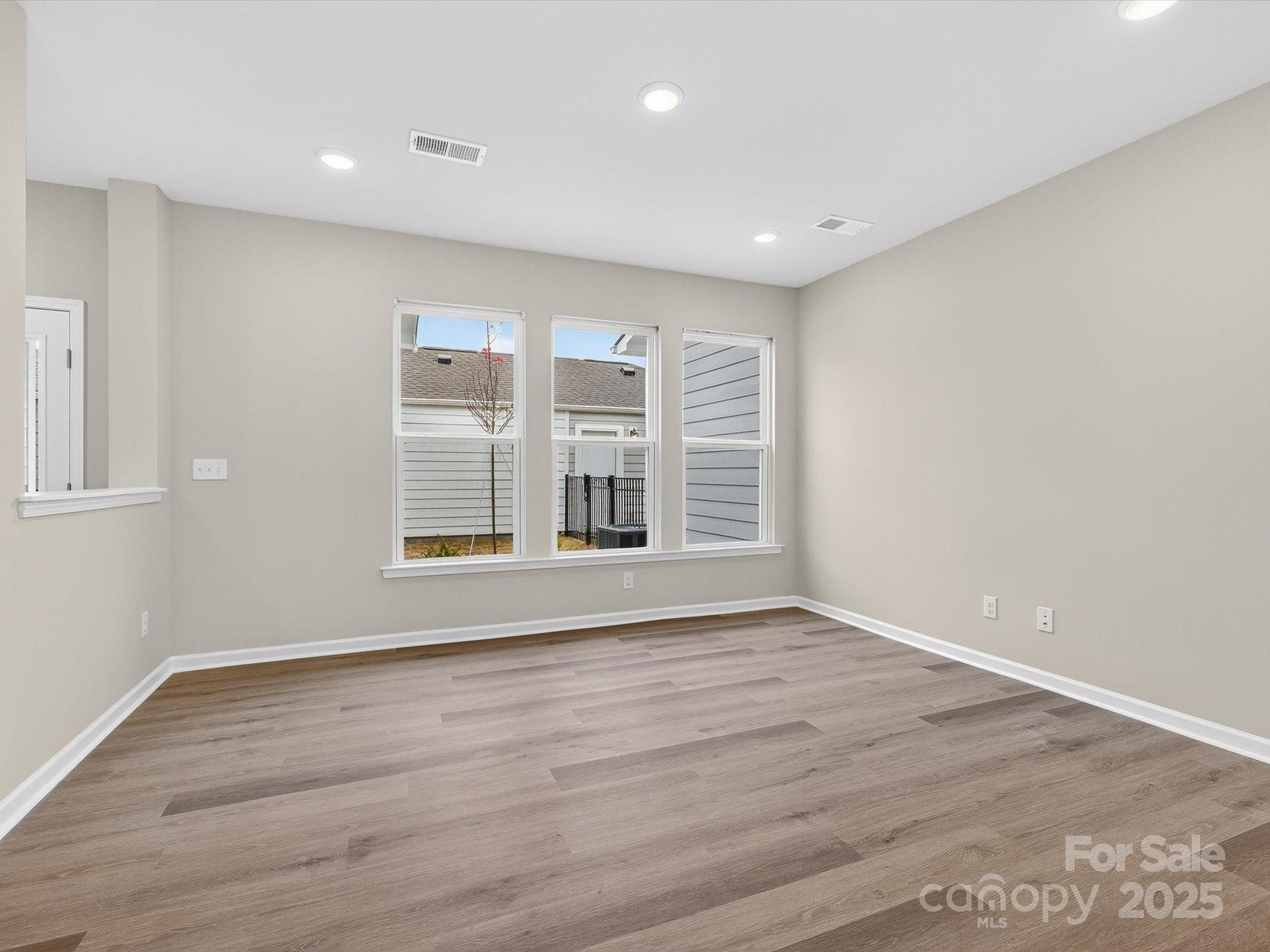 11439 Prosperity Church Road Huntersville, NC 28078 - Photo 13 of 34 a view of an empty room with wooden floor and a window
