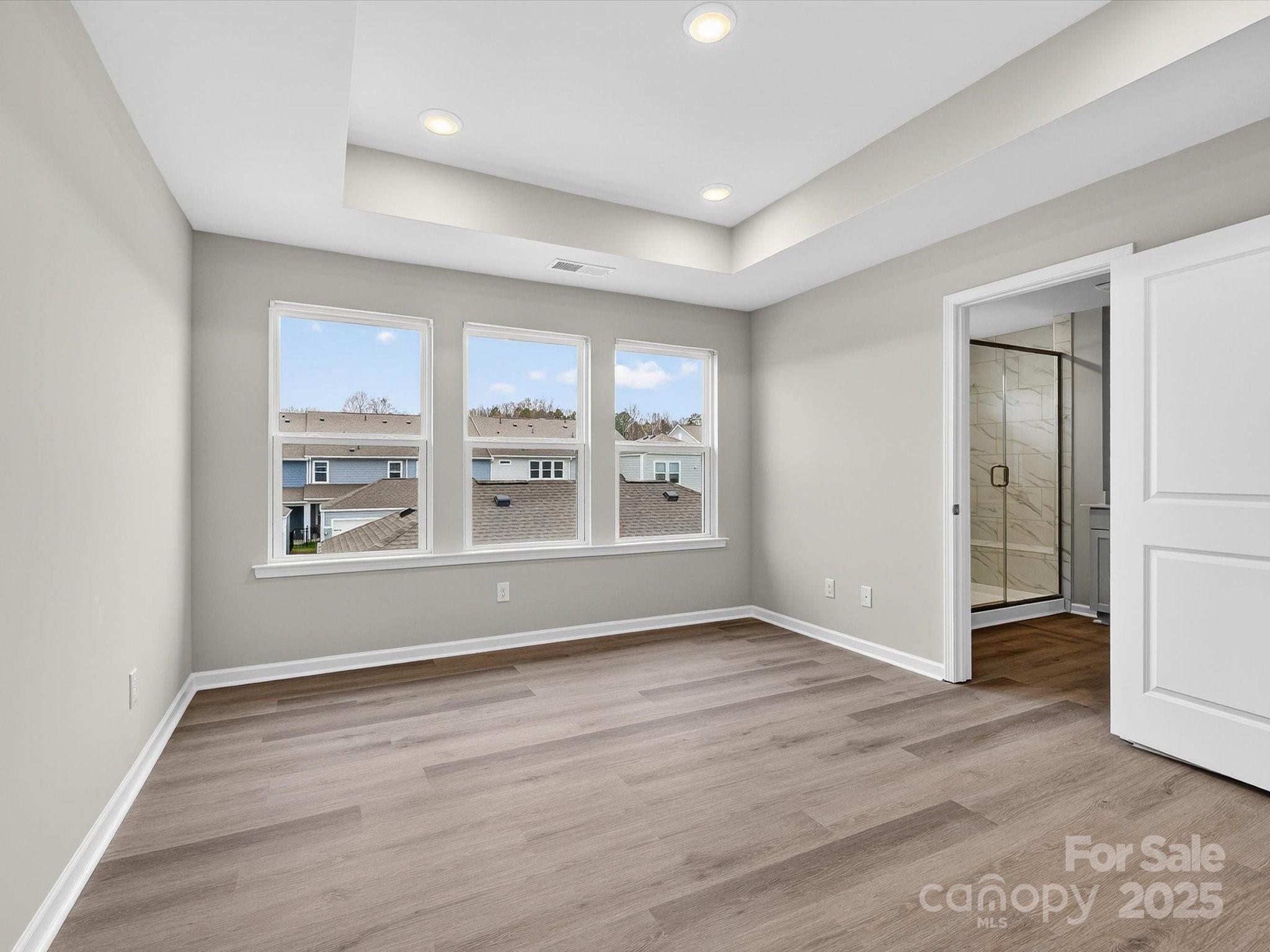 11439 Prosperity Church Road Huntersville, NC 28078 - Photo 18 of 34 a view of an empty room with a window and wooden floor