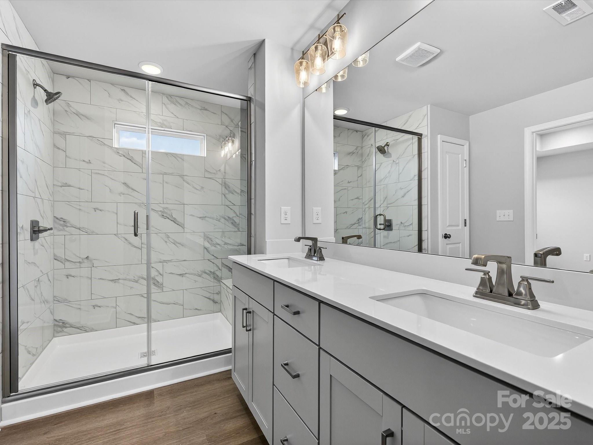 11439 Prosperity Church Road Huntersville, NC 28078 - Photo 21 of 34 a bathroom with a double vanity sink mirror and shower