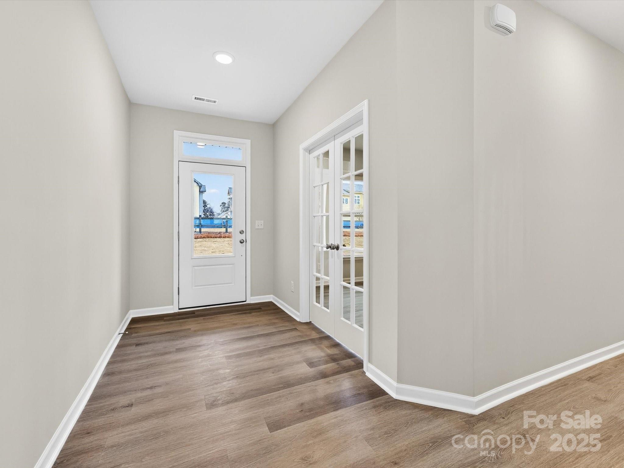 11439 Prosperity Church Road Huntersville, NC 28078 - Photo 3 of 34 a view of a hallway with wooden floor and closet