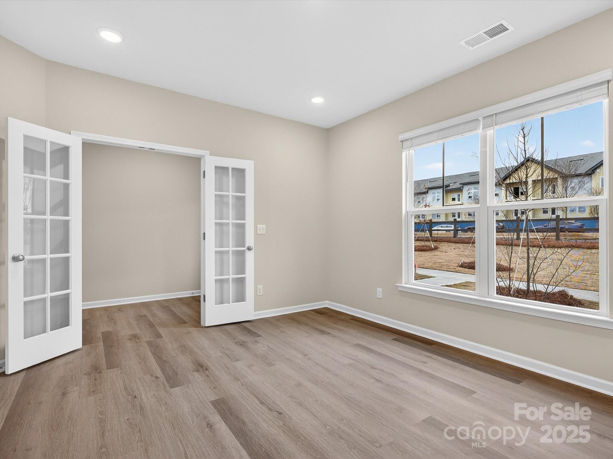 11439 Prosperity Church Road Huntersville, NC 28078 - Photo 5 of 34 an empty room with wooden floor and a window
