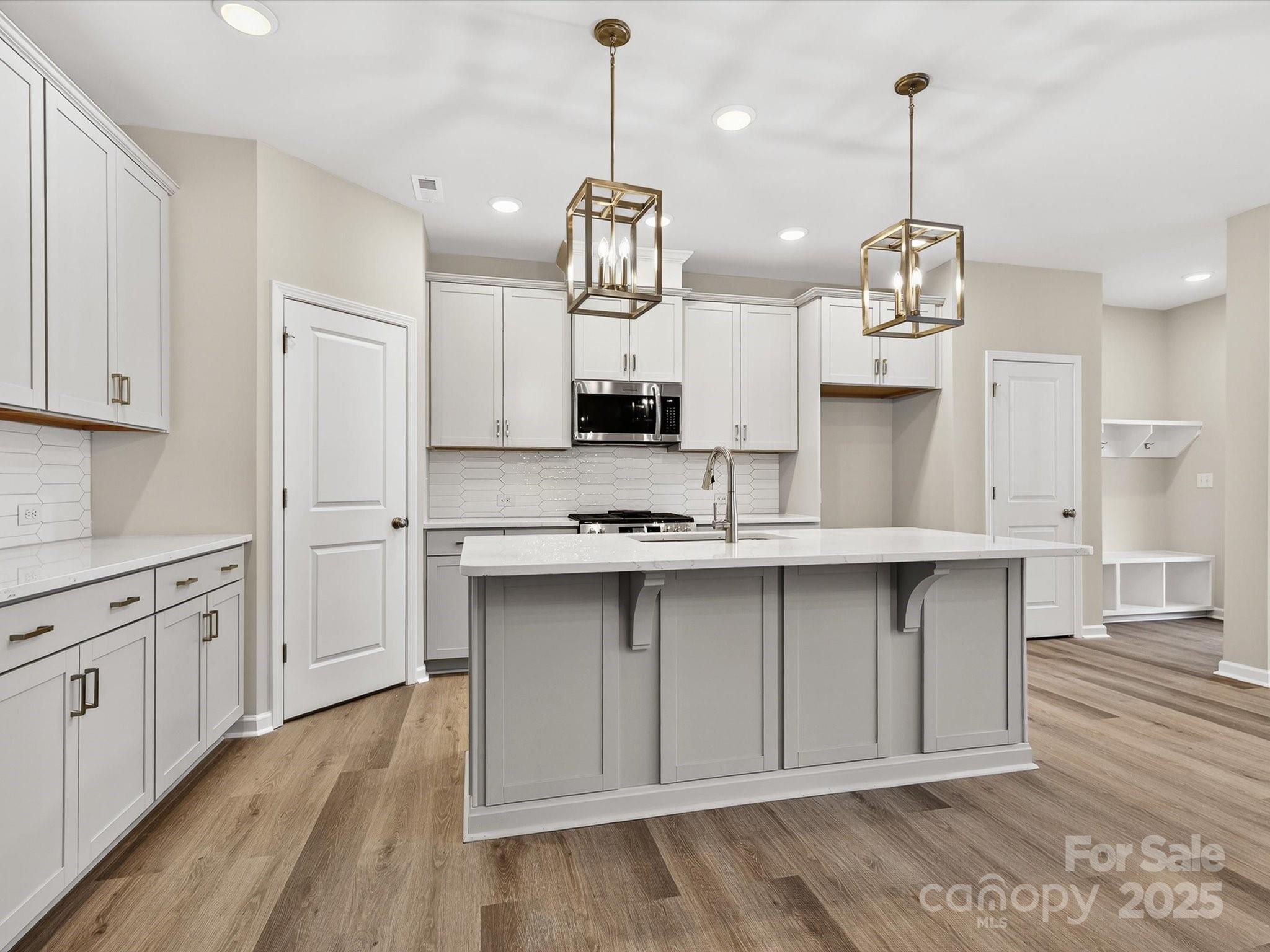 11439 Prosperity Church Road Huntersville, NC 28078 - Photo 7 of 34 a kitchen that has a lot of cabinets and wooden floor