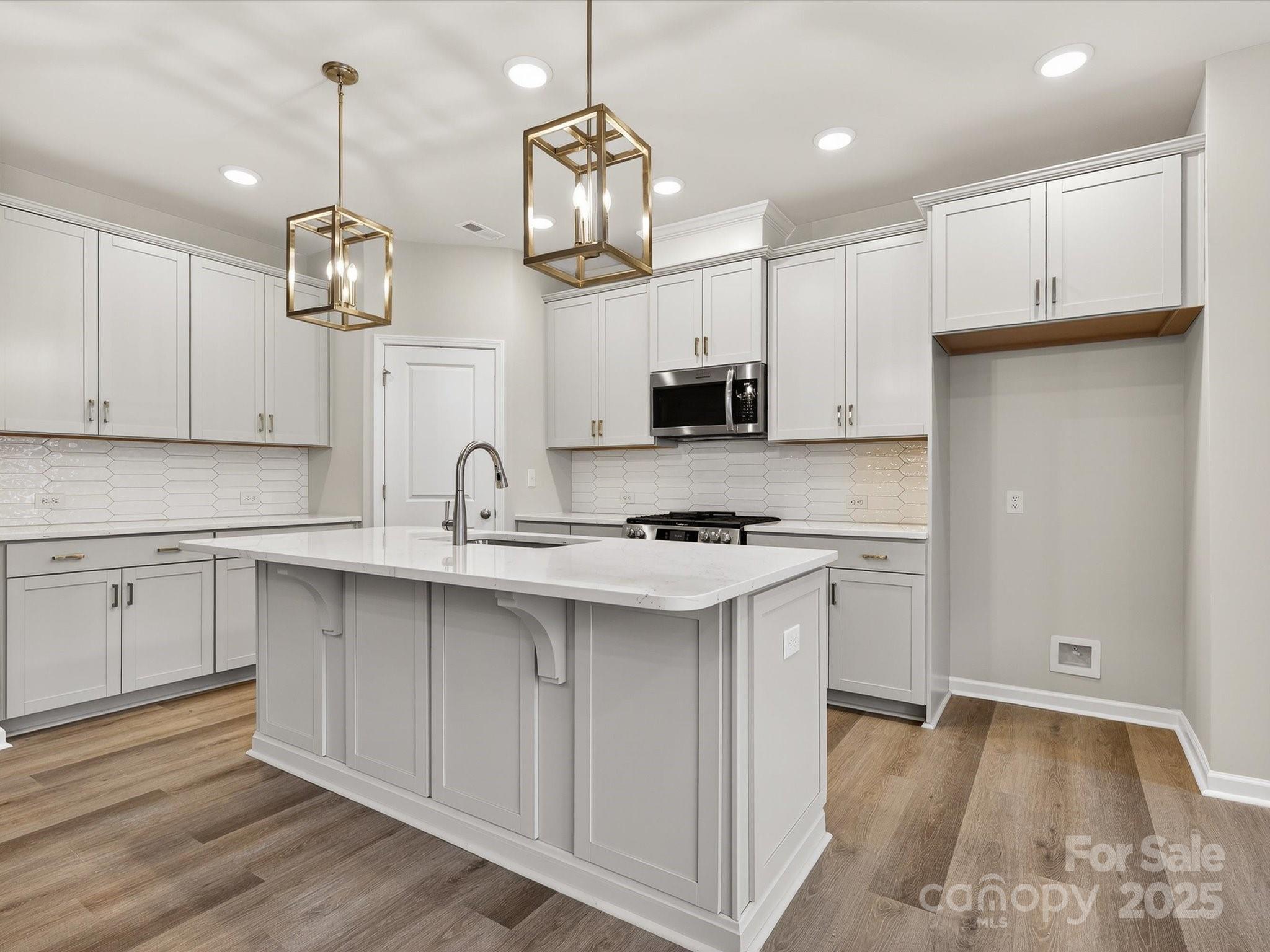 11439 Prosperity Church Road Huntersville, NC 28078 - Photo 9 of 34 a kitchen with kitchen island granite countertop a sink cabinets and stainless steel appliances