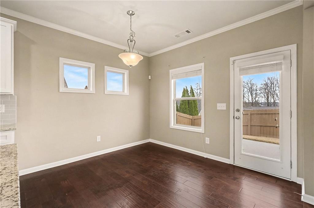 4475 Clubside Drive Gainesville, GA 30504 - Photo 13 of 36 a view of an empty room with a window and wooden floor