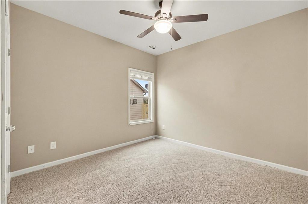4475 Clubside Drive Gainesville, GA 30504 - Photo 19 of 36 an empty room with windows and fan