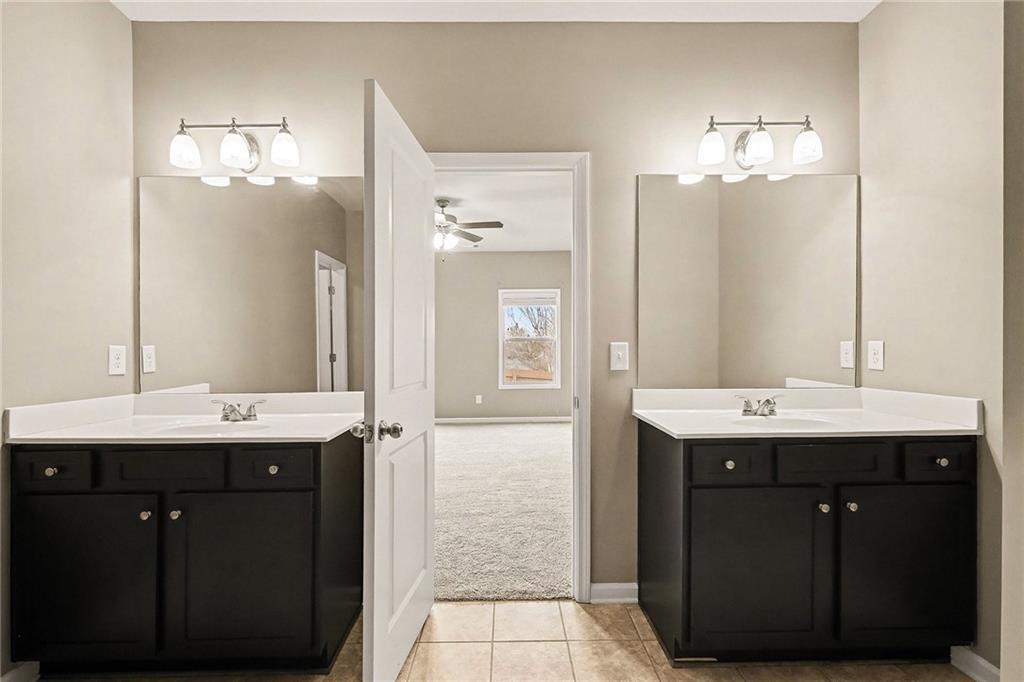 4475 Clubside Drive Gainesville, GA 30504 - Photo 26 of 36 a bathroom with a sink double vanity and a mirror