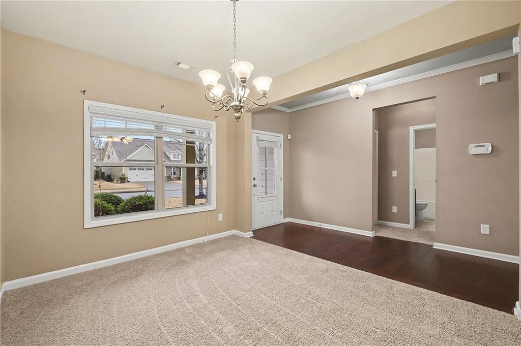 4475 Clubside Drive Gainesville, GA 30504 - Photo 4 of 36 a view of livingroom with window chandelier fan and front door