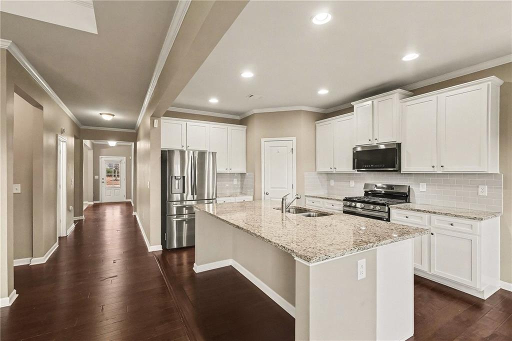 4475 Clubside Drive Gainesville, GA 30504 - Photo 8 of 36 a kitchen with a sink a counter top space stainless steel appliances and cabinets