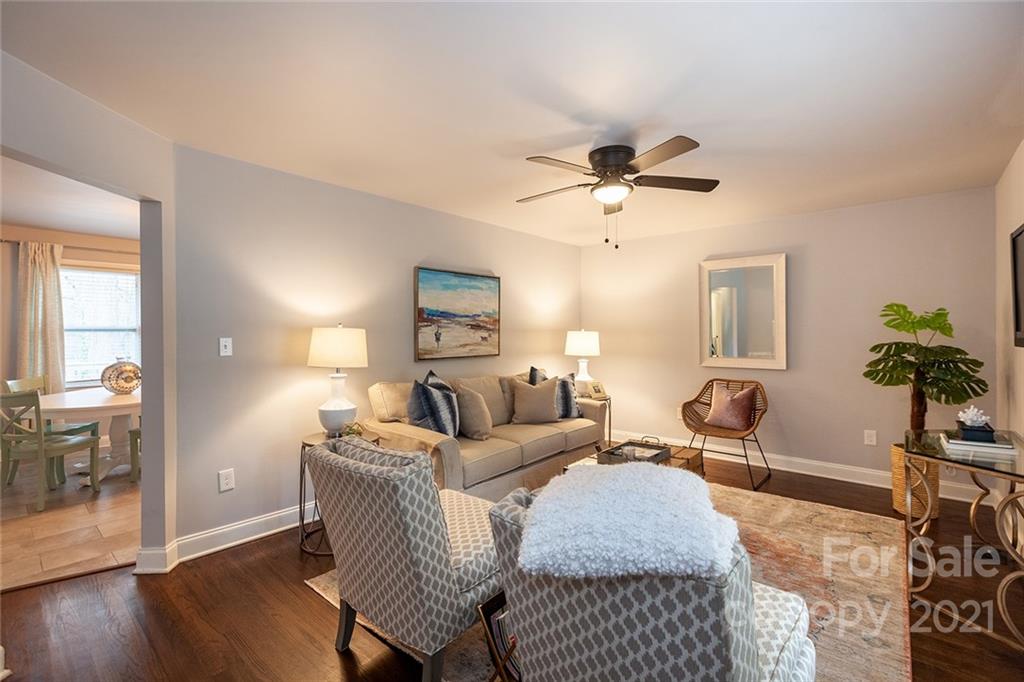 5110 Auburndale Road Charlotte, NC 28205 - Photo 2 of 30 a living room with furniture a chandelier and wooden floor