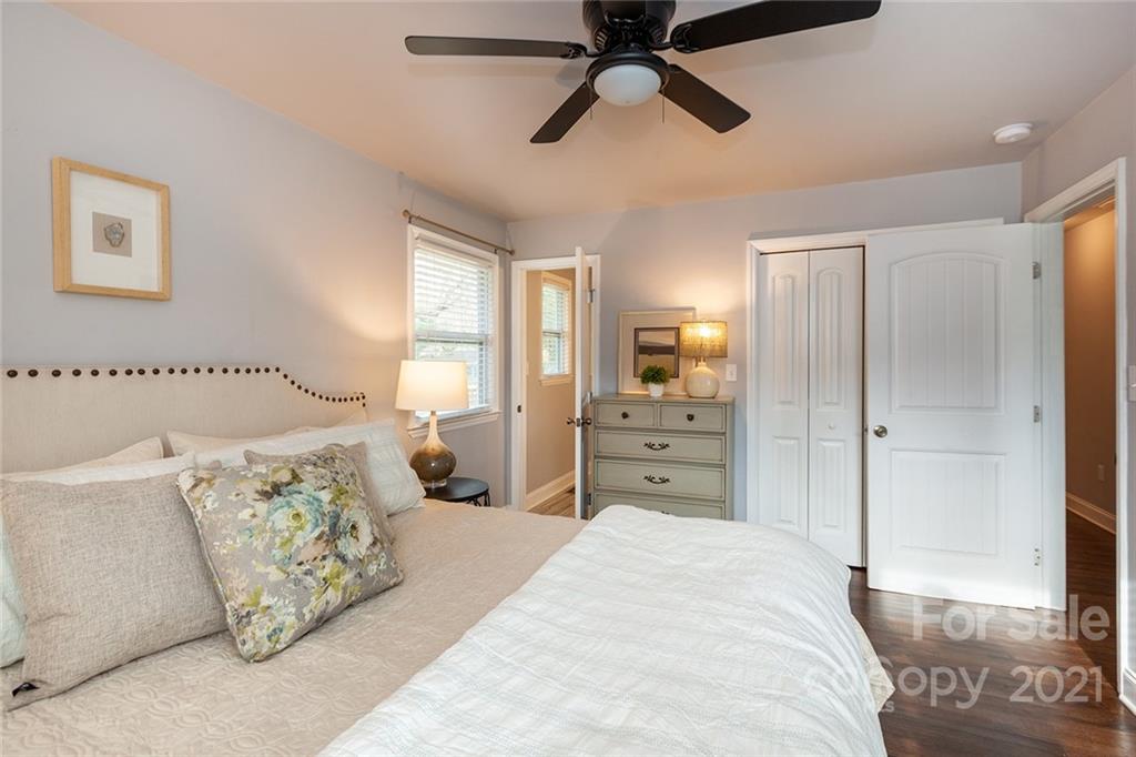 5110 Auburndale Road Charlotte, NC 28205 - Photo 15 of 30 a spacious bedroom with a bed and a chandelier
