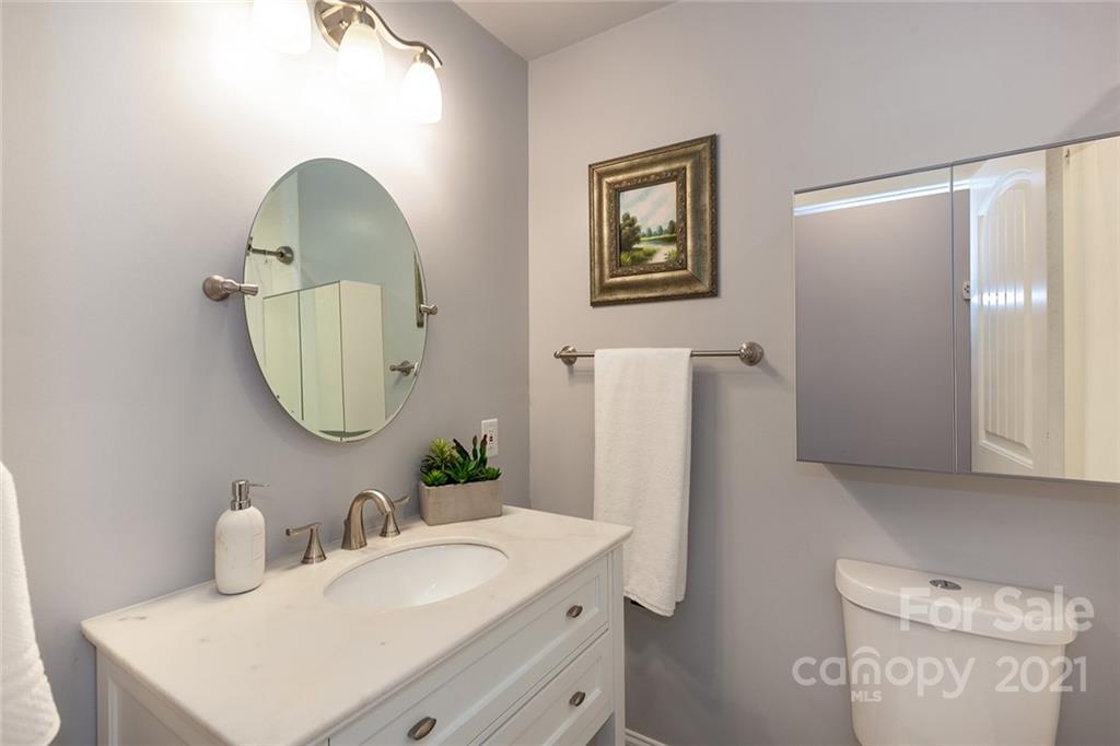 5110 Auburndale Road Charlotte, NC 28205 - Photo 21 of 30 a bathroom with a sink vanity mirror and a toilet