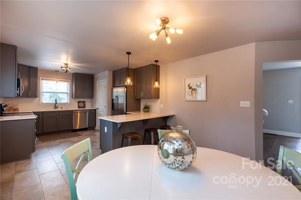 5110 Auburndale Road Charlotte, NC 28205 - Photo 6 of 30 a large kitchen with a table and chairs