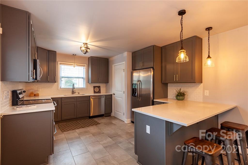 5110 Auburndale Road Charlotte, NC 28205 - Photo 7 of 30 a kitchen with a refrigerator a sink and dishwasher